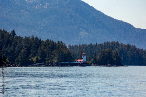 Scenic  photograph of a lighthouse in an Alaska landscape 