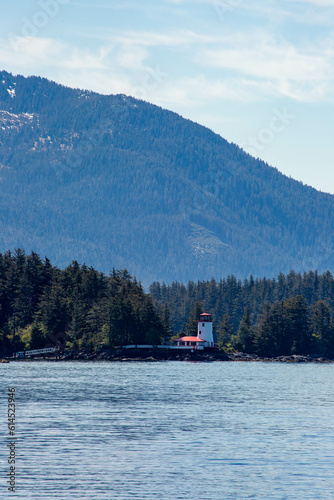 Scenic  photograph of a lighthouse in an Alaska landscape 