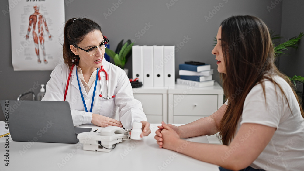 Two women doctor and patient prescribing pills at clinic Two women doctor and patient prescribing pills at clinic