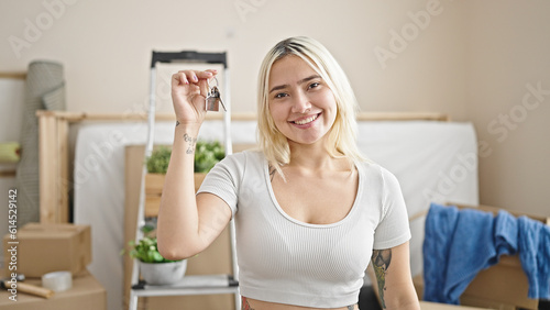 Young beautiful hispanic woman smiling confident holding new house keys at new home
