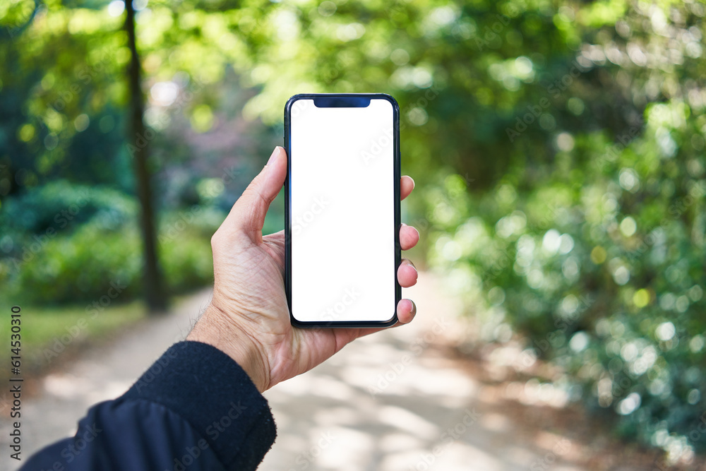 Man holding smartphone showing white blank screen at park
