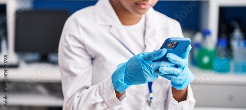 African american woman scientist using smartphone at laboratory