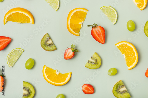 Fototapeta Naklejka Na Ścianę i Meble -  Citrus fruits and strawberries, pattern flat lay, top view. Summer layout on colored background