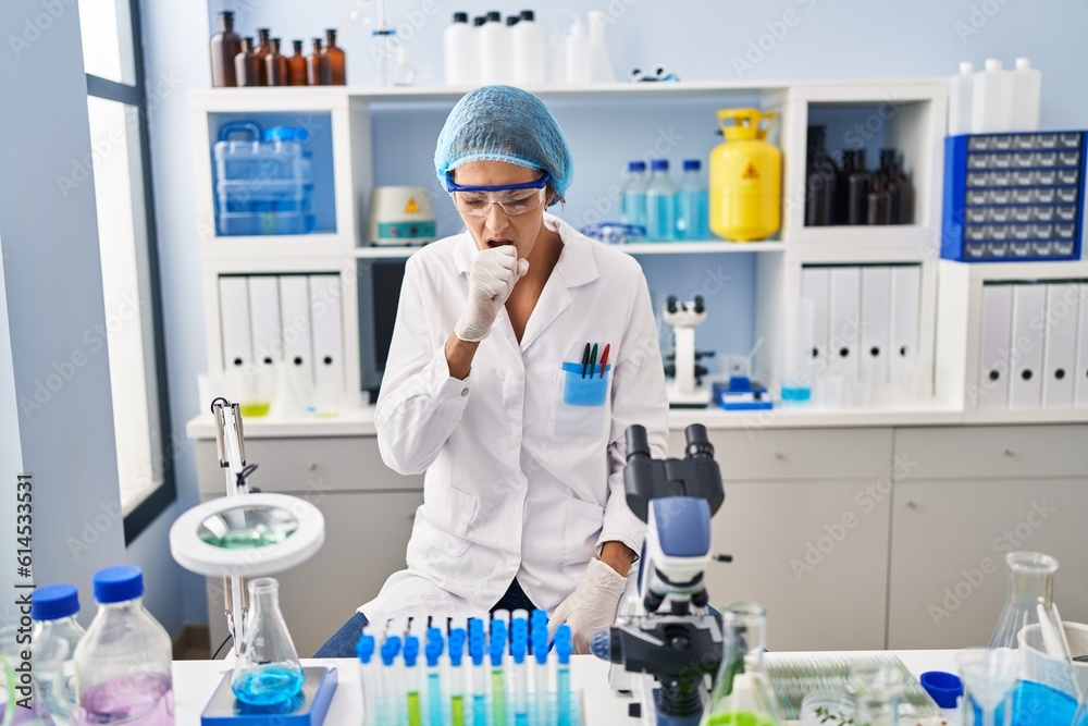Brunette woman working at scientist laboratory feeling unwell and coughing as symptom for cold or bronchitis. health care concept. Brunette woman working at scientist laboratory feeling unwell and coughing as symptom for cold or bronchitis. health care concept.