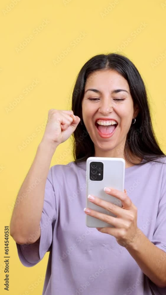 Excited woman celebrating while using the mobile phone Excited woman celebrating while using the mobile phone