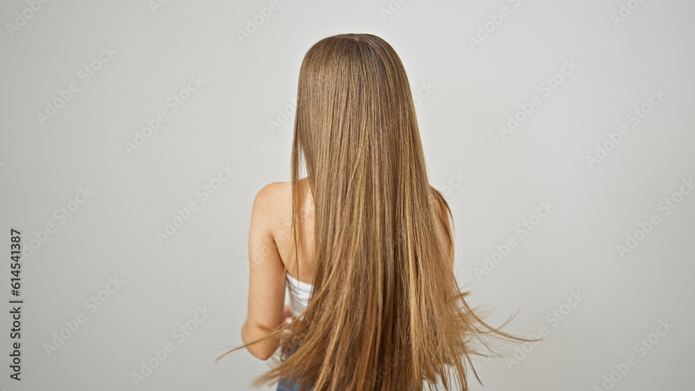 Young beautiful girl standing backwards over isolated white background Young beautiful girl standing backwards over isolated white background