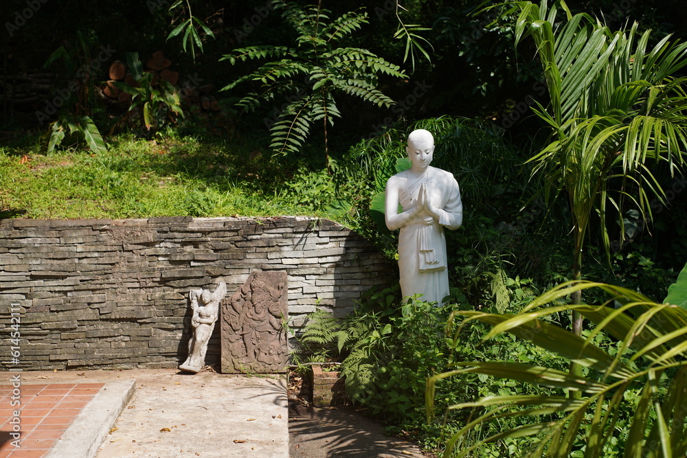 Budda statue walking in the garden Budda statue walking in the garden