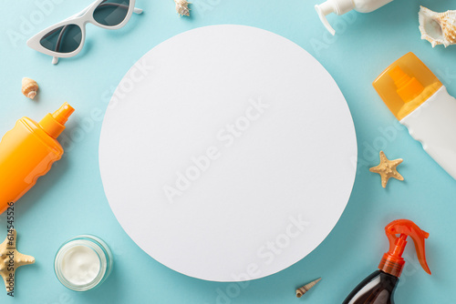 Safe beach tan concept. Above view photo of empty circle surrounded by sunglasses, marine shells and sunscreen sprays and cream on celeste isolated background with copy-space