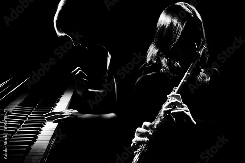 Musical duet piano and flute player. Pianist and flutist classical musicians photo
