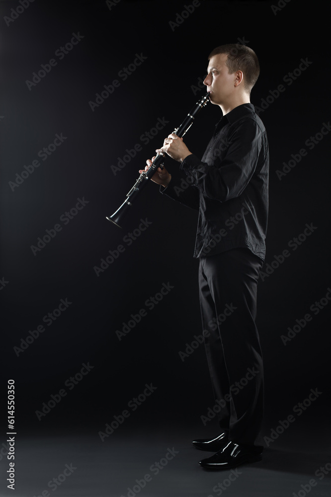 Naklejka premium Clarinet player classical musician. Man playing clarinette