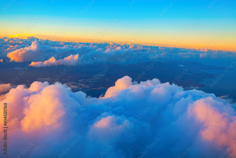 Twilight over the clouds . Canary islands view from above through clouds