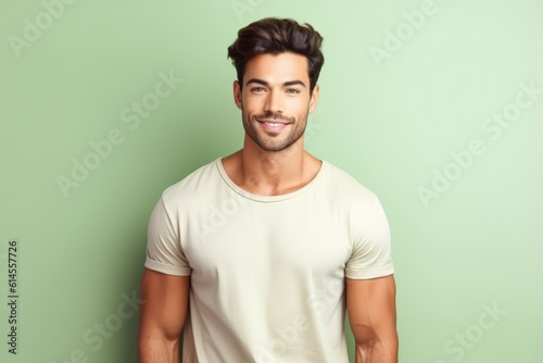 Portrait of a muscular handsome guy wearing a plain t-shirt, isolated on a pastel background. Generative AI illustration.