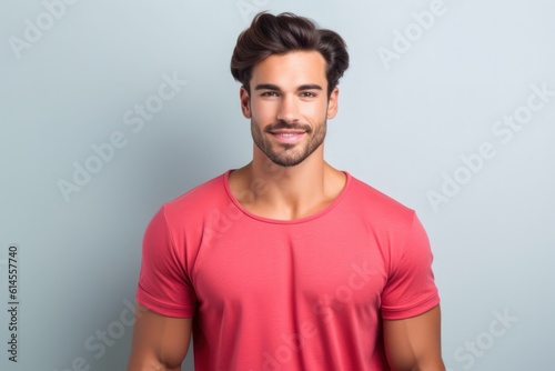 Portrait of a muscular handsome guy wearing a plain red t-shirt, isolated on a pastel background. Generative AI illustration.