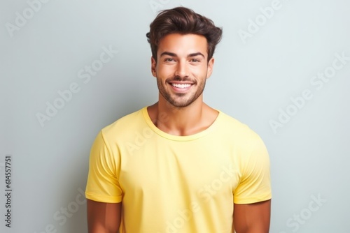 Portrait of a muscular handsome guy wearing a plain yellow t-shirt, isolated on a pastel background. Generative AI illustration. © Tuyres