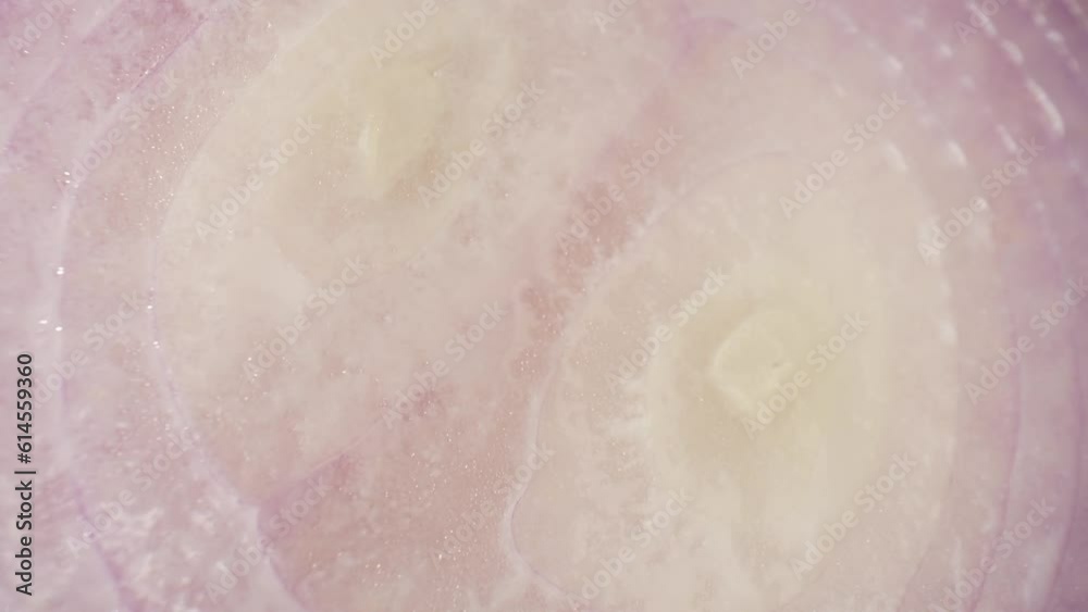 Mesmerizing macro video captures the intricate layers and vibrant hues of half-cut red onions. A probe lens unveils their stunning beauty in exquisite detail. Red onions background
Mesmerizing macro video captures the intricate layers and vibrant hues of half-cut red onions. A probe lens unveils their stunning beauty in exquisite detail. Red onions background