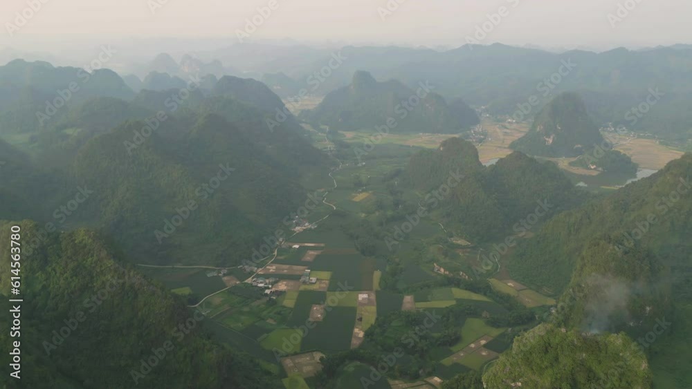 Aerial top view of fresh paddy rice terraces, green agricultural fields in countryside or rural area of Cao Bang, mountain hills valley in Asia, Vietnam, China border. Nature landscape background. Aerial top view of fresh paddy rice terraces, green agricultural fields in countryside or rural area of Cao Bang, mountain hills valley in Asia, Vietnam, China border. Nature landscape background.