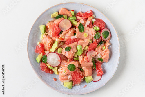 Fresh homemade Chilean salmon ceviche with grapefruit, avocado, radish, onion and mint. Healthy diet food