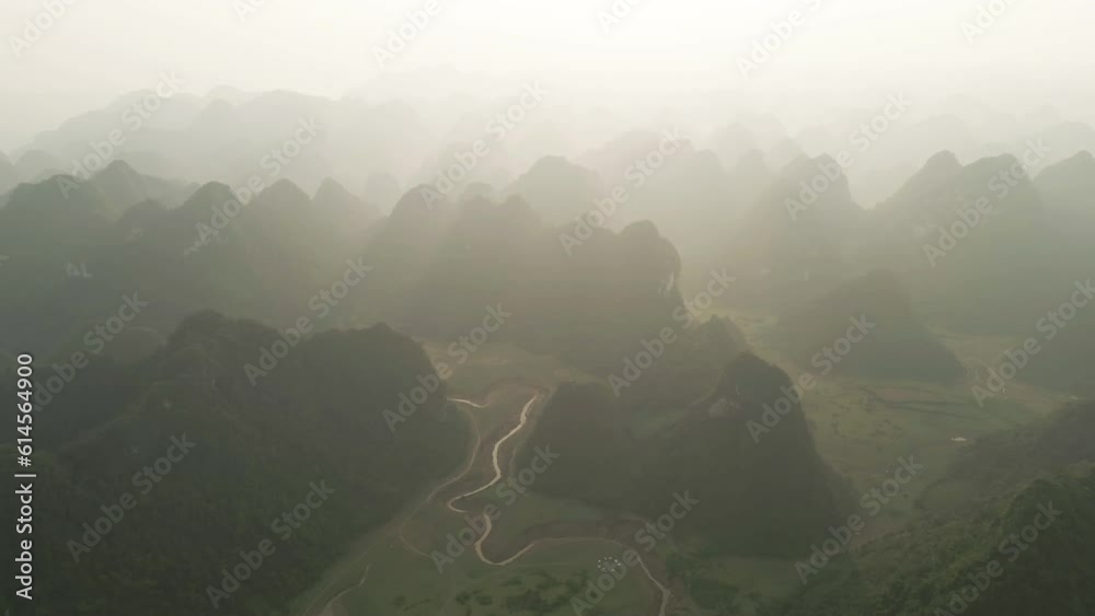Aerial top view of fresh paddy rice terraces, green agricultural fields in countryside or rural area of Cao Bang, mountain hills valley in Asia, Vietnam, China border. Nature landscape background.