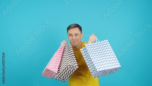 Man dancing and smiling with shopping bags