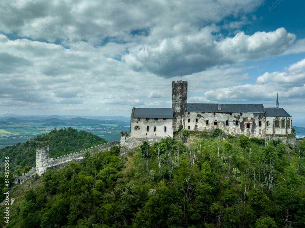 Aerial view of Bezdez castle with ruined palace and church building towering over the surrounding countryside