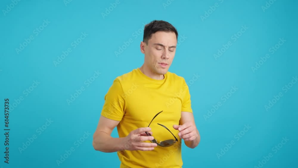 A pimp man trying to put on his sunglasses