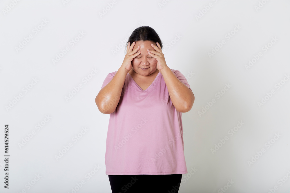 Beautiful Asian plus-size woman smiles with positive emotion, feeling happy and proud of her body overweight. Portrait shot on white background with copy space. Beautiful Asian plus-size woman smiles with positive emotion, feeling happy and proud of her body overweight. Portrait shot on white background with copy space.