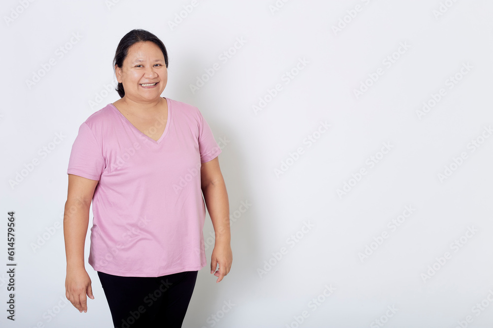 Beautiful Asian plus-size woman smiles with positive emotion, feeling happy and proud of her body overweight. Portrait shot on white background with copy space. Beautiful Asian plus-size woman smiles with positive emotion, feeling happy and proud of her body overweight. Portrait shot on white background with copy space.