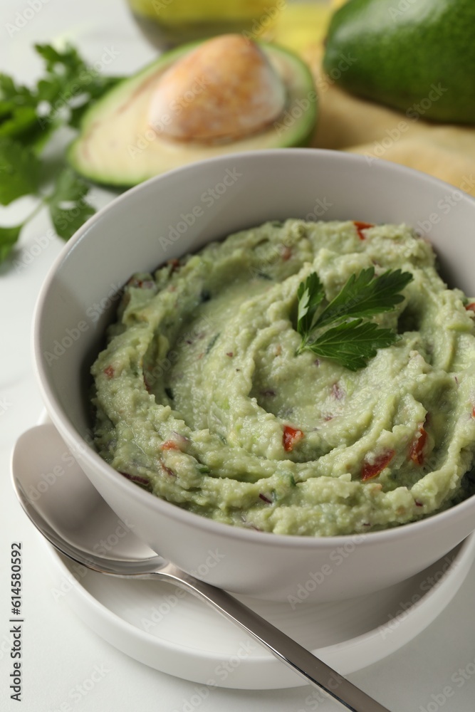 Delicious guacamole served on white table, closeup Delicious guacamole served on white table, closeup