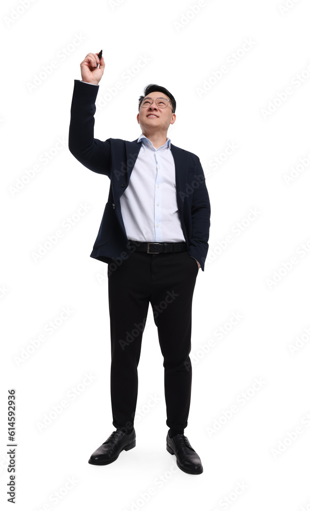 Businessman in suit with marker writing on white background, low angle view Businessman in suit with marker writing on white background, low angle view