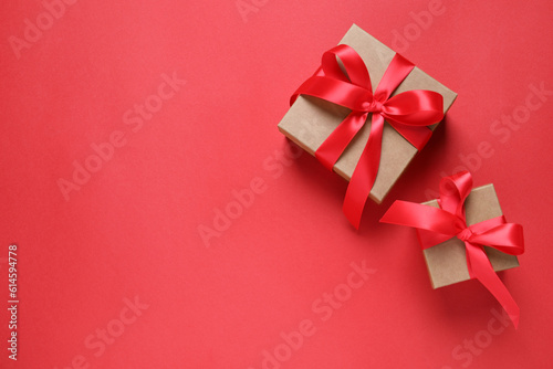 Beautiful gift boxes on red background, flat lay. Space for text © New Africa