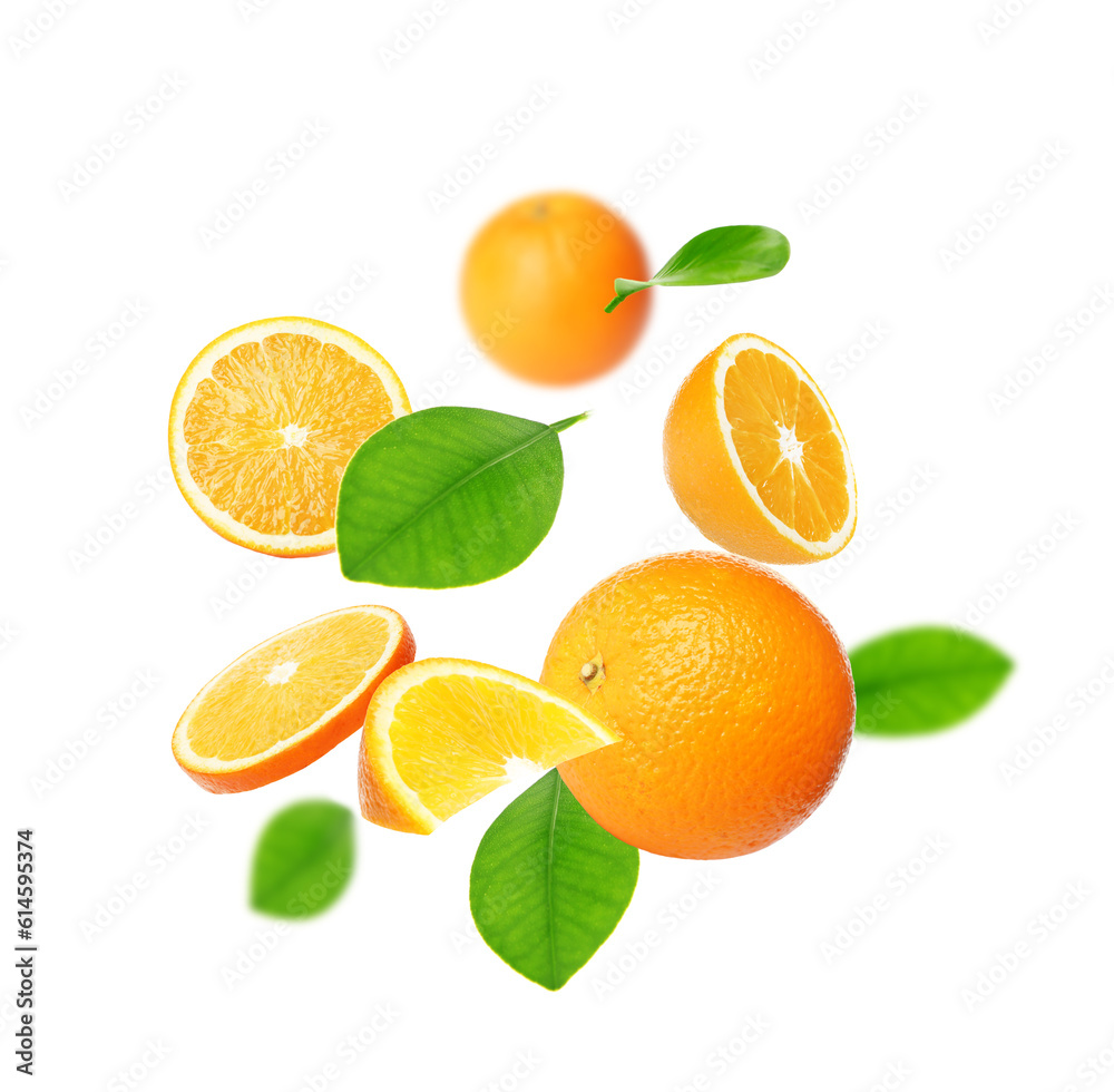 Cut and whole oranges with green leaves flying on white background