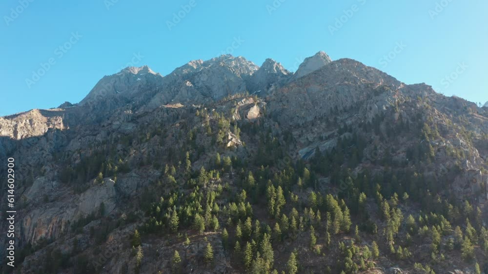 Majestic Mountain Peaks Of Sangla Valley Against Blue Sky In Himachal Pradesh, India. wide aerial Majestic Mountain Peaks Of Sangla Valley Against Blue Sky In Himachal Pradesh, India. wide aerial
