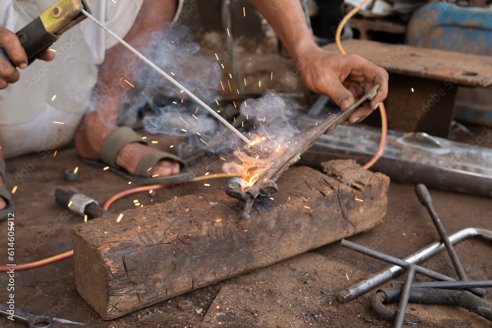 Welders work on welding metal. Men working in welding workshop Welders work on welding metal. Men working in welding workshop