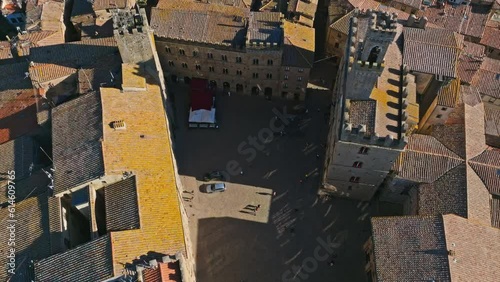 Aerial overhead of the Palace of the Priors, Palazzo dei Priori, Volterra, Province of Siena, Italy. Drone overhead orbit shot photo