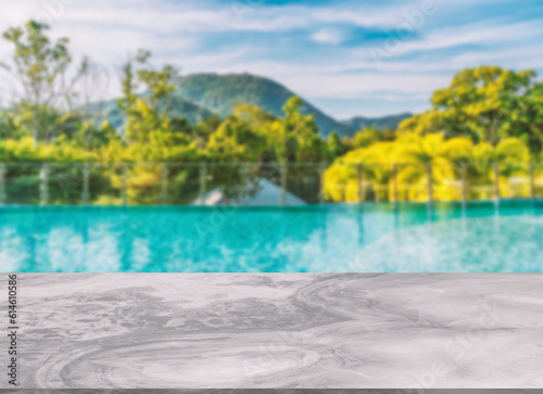 Beautiful marble table or desk floor  little shiny surface  perspective view  the background of rooftop swimming pool and mountain scape and sky  Empty space for products to put on the table.