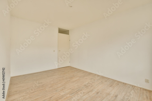 an empty room with white walls and wood flooring the room is clean and ready to be used for storage