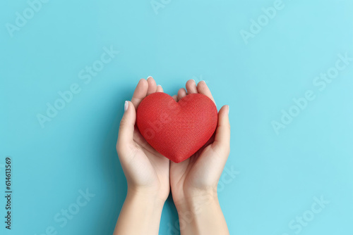 Close-up of hands holding small red toys heart