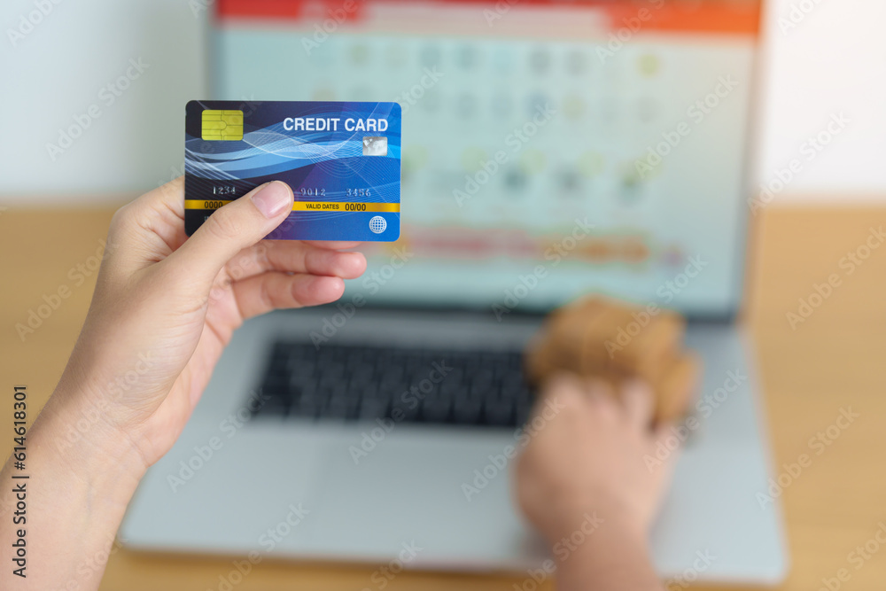 woman hand holding credit card and using laptop with mobile phone for online shopping while making order. Marketplace platform website, technology, ecommerce, shipping delivery and online payment woman hand holding credit card and using laptop with mobile phone for online shopping while making order. Marketplace platform website, technology, ecommerce, shipping delivery and online payment