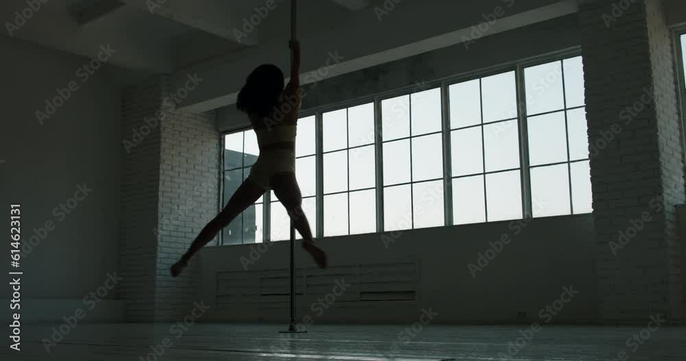 Young Asian strippers girl dances on a pylon and spins on it bright studio big windows background. Slow motion. In light underwear, woman power, dark hair brunette. Sexy slim legs spinning on pylon Young Asian strippers girl dances on a pylon and spins on it bright studio big windows background. Slow motion. In light underwear, woman power, dark hair brunette. Sexy slim legs spinning on pylon