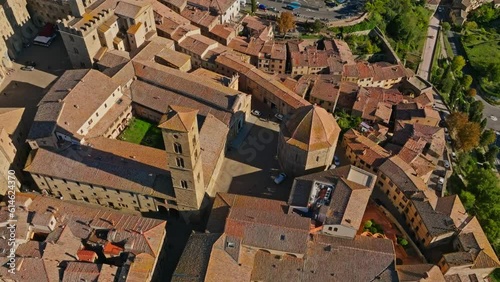 Aerial around town of Volterra and the Palace of the Priors, Palazzo dei Priori, Volterra, Province of Siena, Italy. Drone overhead orbit shot photo
