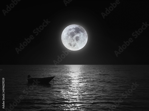 Bright and beautiful dramatic super moon over the ocean with small boat and reflection of bright light in black and white. Image use for imply loneliness mood background. Moon image furnished by NASA © ekapolsira