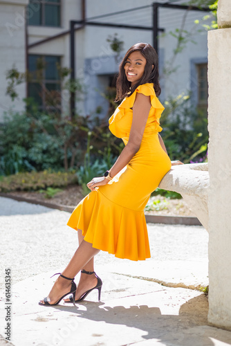 portrait of young afro woman in the streets of lyon france. yellow dress.