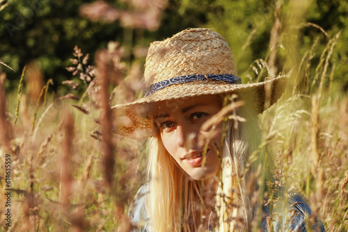 Portrait of a young blonde woman in nature