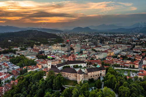Ljubljana, Slovenia - Aerial panoramic view of Ljubljana Castle (Ljubljanski grad) on a summer afternoon with skyline of the capital of Slovenia and colorful sunset sky