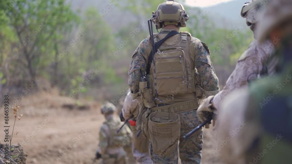 Team of U.S. Army marine corps soldier military war with gun weapon participating and preparing to attack the enemy in Thailand during exercise Cobra Gold training in battle. Combat force.