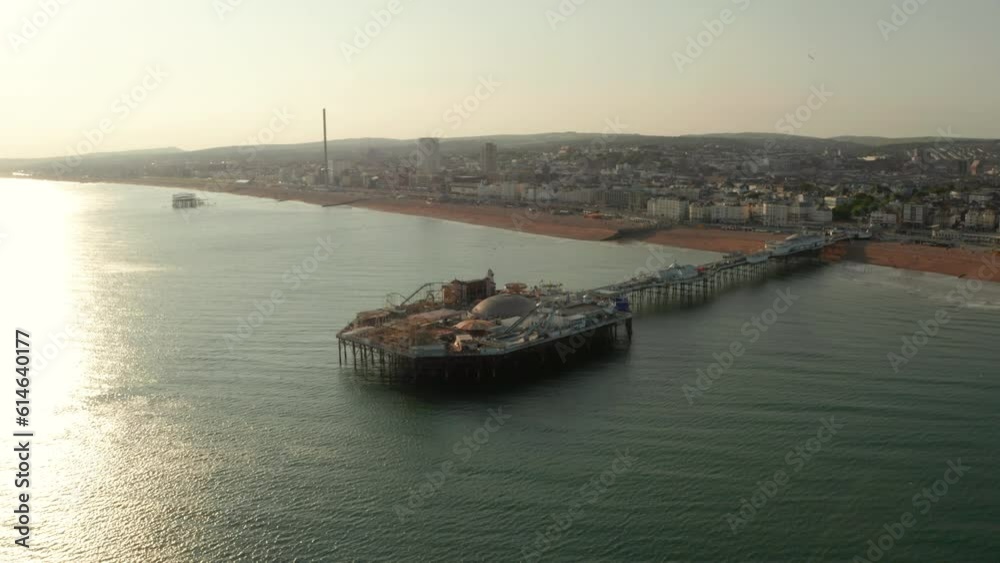Low aerial shot over Brighton Pier towards the beach and town centre Low aerial shot over Brighton Pier towards the beach and town centre