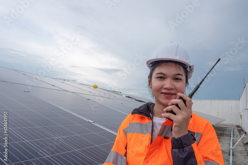 Female engineers check the operation of solar panels, Sustainable, Renewable, Green energy.