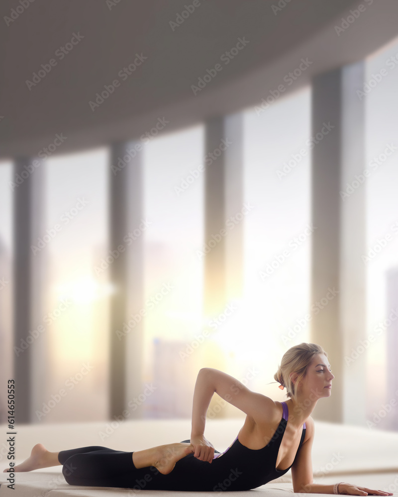 Athletic woman in black sporty uniform practicing yoga in light studio, The woman's impressive pose serves as an inspiration for others to push their limits Athletic woman in black sporty uniform practicing yoga in light studio, The woman's impressive pose serves as an inspiration for others to push their limits