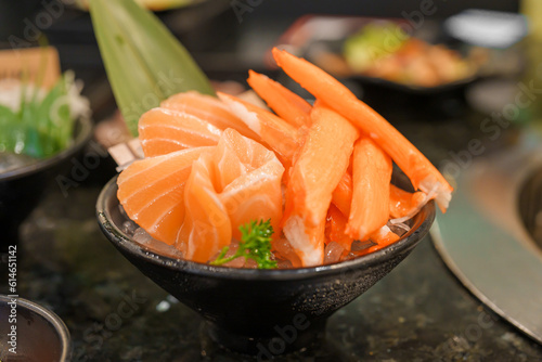 Fresh Japanese Sashimi set in Asian restaurant, orange Salmon and tuna sashimi fish on dish with ice. Japan food concept