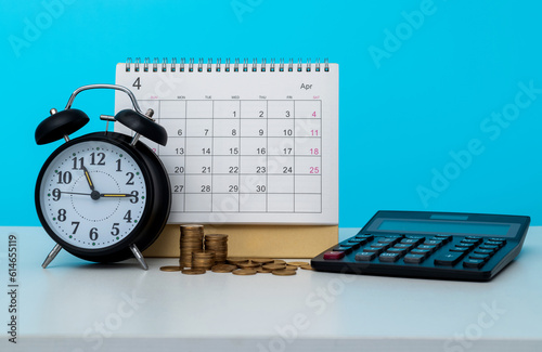 Alarm clock and calendar on office table photo